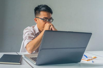 Man using laptop on table