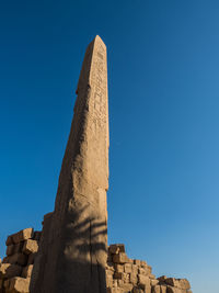Low angle view of historical building against blue sky