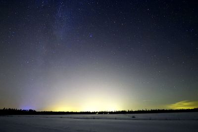 Scenic view of field against sky at night