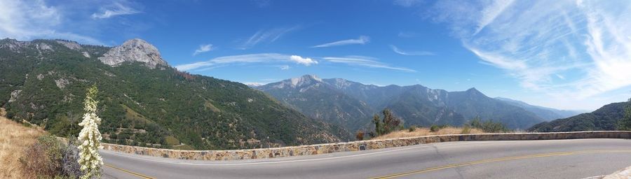 Panoramic view of road by mountains against sky