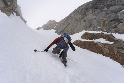 People on snowcapped mountains during winter