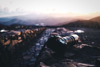Digital camera on stone wall at sunset