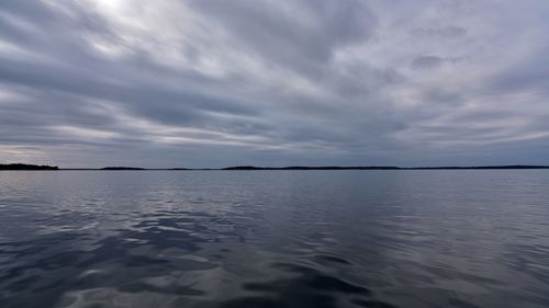 View of calm sea against cloudy sky