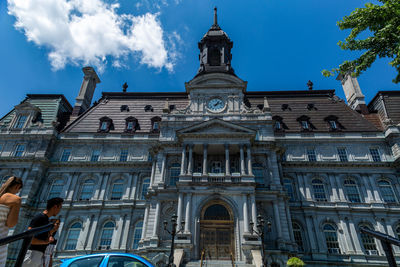 Low angle view of building against cloudy sky