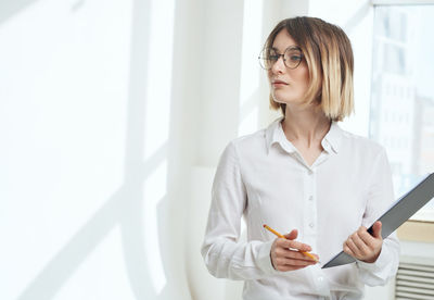 Portrait of young woman using mobile phone