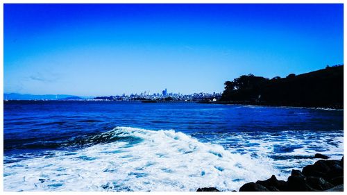 Scenic view of sea against clear blue sky