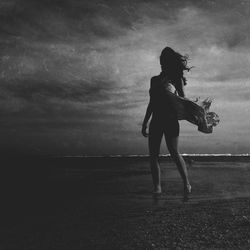 Full length of woman standing against sky