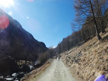 Road amidst plants and mountains against sky