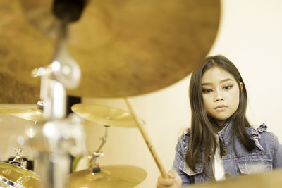 Low angle view of girl playing musical instrument