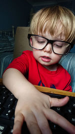 Portrait of boy sitting at home