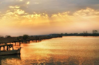 Scenic view of canal against sky during sunset