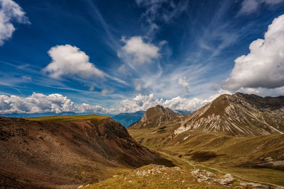 Scenic view of mountains against cloudy sky