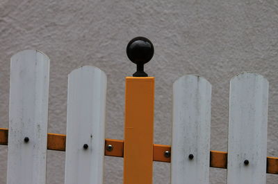 Close-up of metallic structure on wood against wall