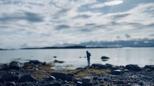 Rocks on beach against sky