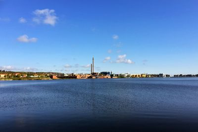 View of cityscape against blue sky