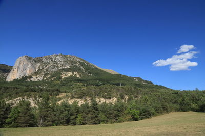 Scenic view of mountains against clear blue sky