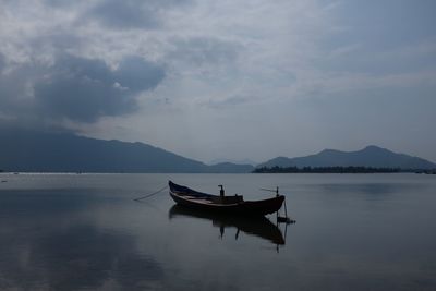 People on boat against sky