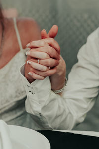 Midsection of woman holding hands