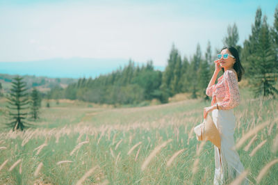 Woman on field against sky