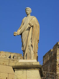 Low angle view of statue against sky