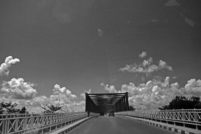 Footbridge over road against sky