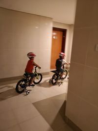 People riding bicycle on tiled floor