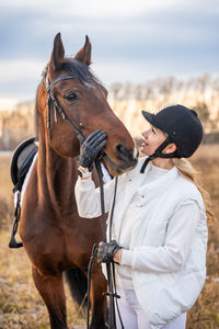 Rear view of man riding horse on field