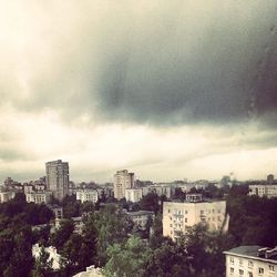 Buildings against cloudy sky