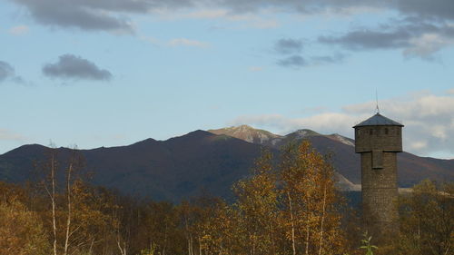 Scenic view of mountains against cloudy sky