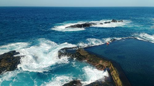 High angle view of waves in sea against sky