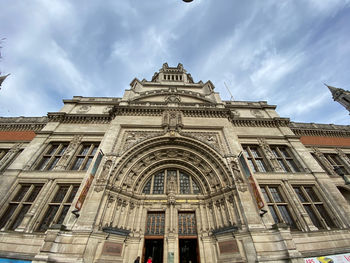 Low angle view of victoria and albert miseum building against cloudy sky