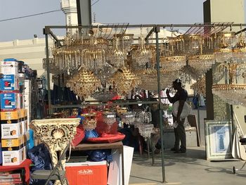 People working at market stall in city