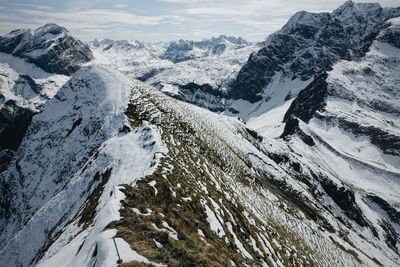 Scenic view of snowcapped mountains against sky