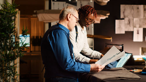 Side view of business colleagues working at office