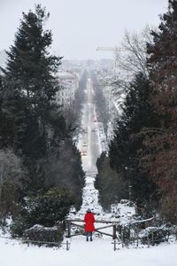 Rear view of people on snow covered land against sky