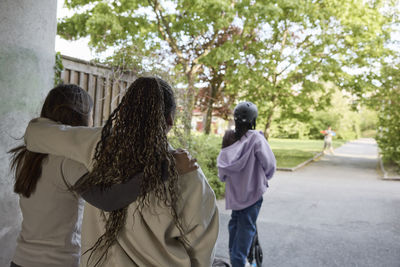 Rear view of teenage girls walking together