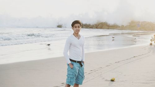 Full length of woman standing on beach