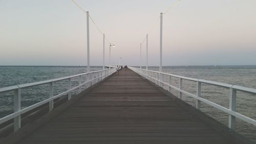 Pier over sea against clear sky