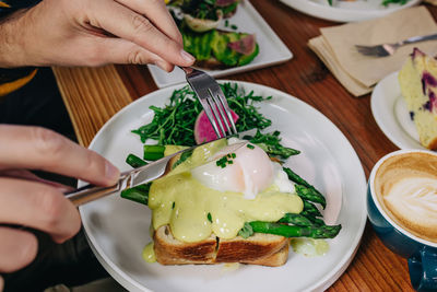 Cropped hand of person preparing food