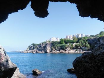 Rock formations in sea against sky