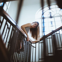 Young woman sitting on staircase