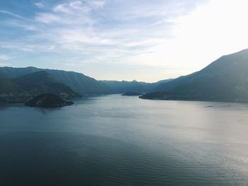 Scenic view of sea and mountains against sky