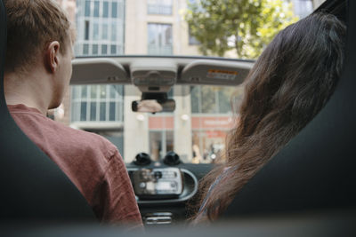 Rear view of couple traveling in car