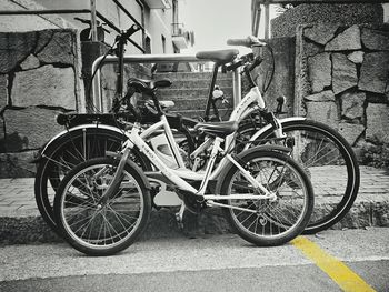 Bicycle parked against wooden wall