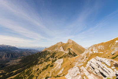 Scenic view of mountains against blue sky