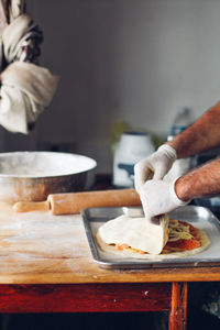 Midsection of man preparing food in kitchen