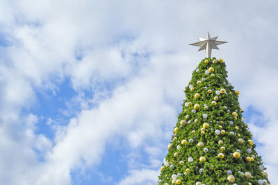 Low angle view of christmas tree against sky