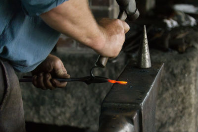 Midsection of man working in workshop