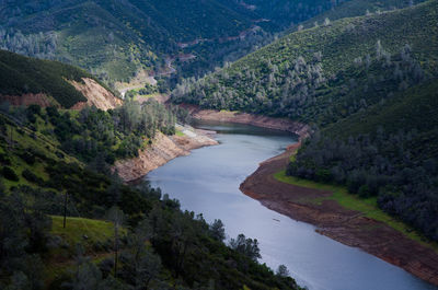 High angle view of river amidst trees against sky