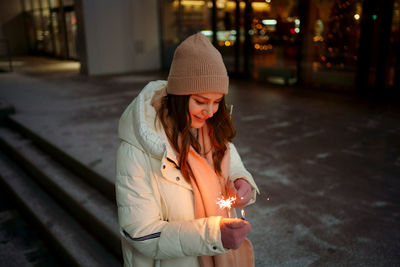 Caucasian white girl with sparklers christmas shopping